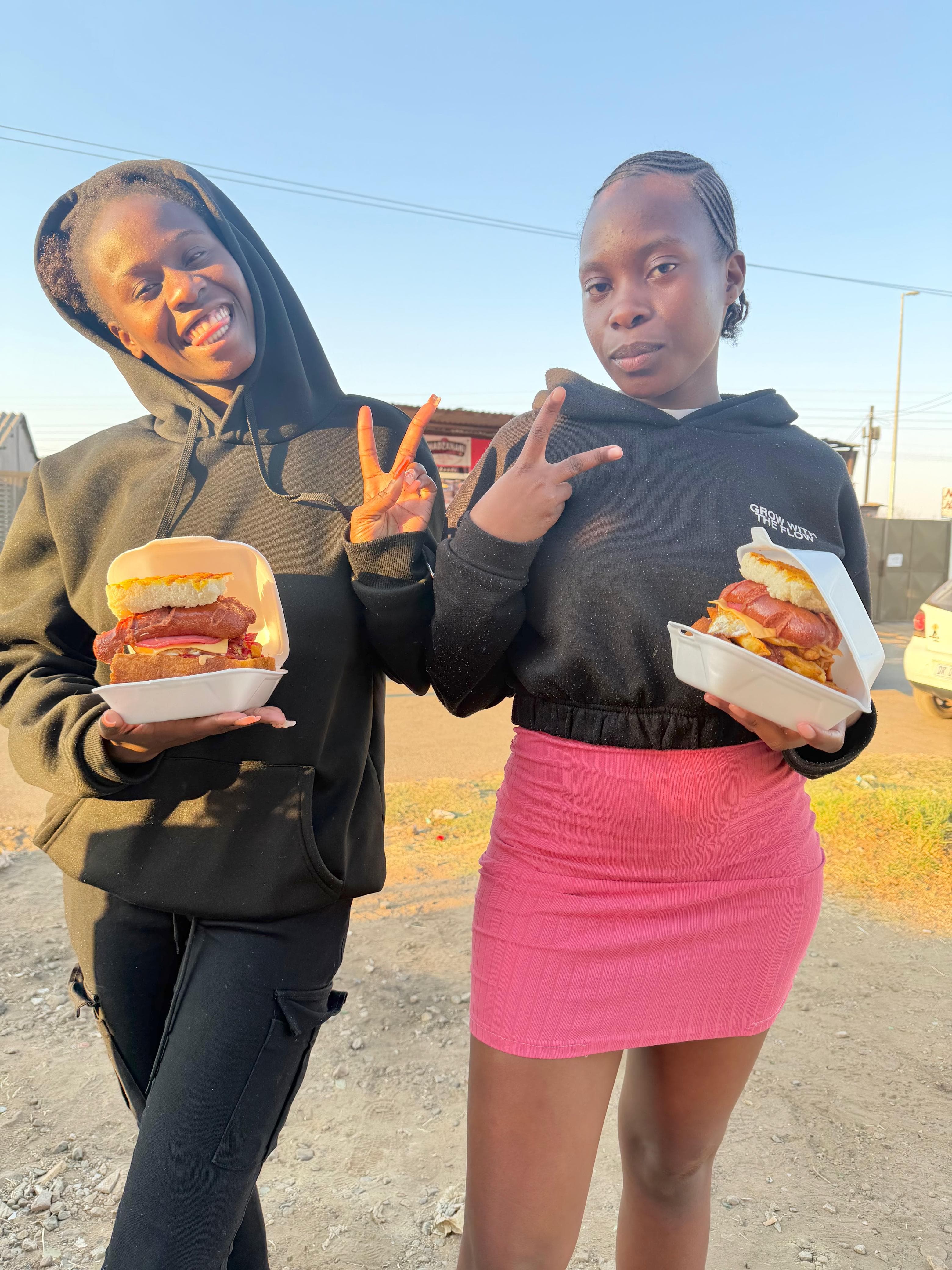 Friends holding kotas from Vhadzanani Kitchen